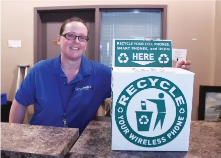  ??  ?? Thonda Richey, store manager at Goodwill, stands near a box for disposing of e-waste.