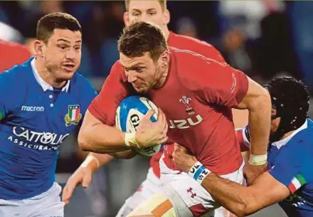  ?? AFP PIC ?? Wales centre Owen Watkin is tackled by Italy fly half Ian McKinley (right) during their Six Nations match on Saturday.