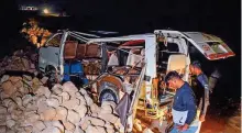  ?? AFP ?? The damaged passenger mini bus after it fell into a water-filled ditch in Sindh province.