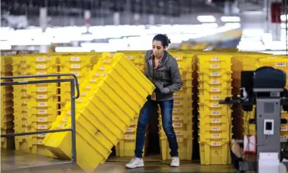  ?? Photograph: Johannes Eisele/AFP/Getty Images ?? A woman at work in the 855,000 sq ft Amazon fulfilment centre in Staten Island, New York.