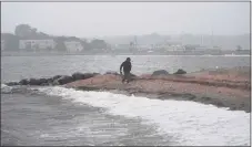  ?? Brian A. Pounds / Hearst Connecticu­t Media ?? Heavy rains and surf from the remnants of Tropical Storm Henri at Gulf Beach in Milford on Aug. 23.