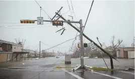  ?? AP PHOTO ?? DIRE PICTURE: A snapped pole is seen in Rockport, Texas, where the mayor says the coastal city was ‘devastated’ by Hurricane Harvey, taking the storm’s full wrath this week.