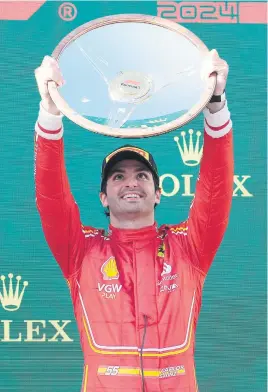  ?? Picture: Getty Images ?? SUCCESS. Spanish Ferrari driver Carlos Sainz celebrates with the trophy after winning Australian F1 Grand Prix at Albert Park yesterday.