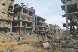  ?? ?? A MAN walks past destroyed buildings in Gaza City, on Jan. 15, 2024. The Palestinia­n death toll from ongoing Israeli attacks on the Gaza Strip has risen to 24,285, the Gaza-based Health Ministry said on Tuesday. (Xinhua)