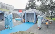  ??  ?? Paramedics work Thursday at an emergency structure set up to increase capacity at a hospital in Brescia, Italy.