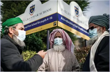  ??  ?? PROTEST: Muslims gather at Batley Grammar after a teacher showed pupils a cartoon of the Prophet