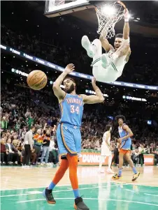  ?? — AFP photo ?? Jayson Tatum of the Boston Celtics reacts after dunking over Kenrich Williams of the Oklahoma City Thunder.