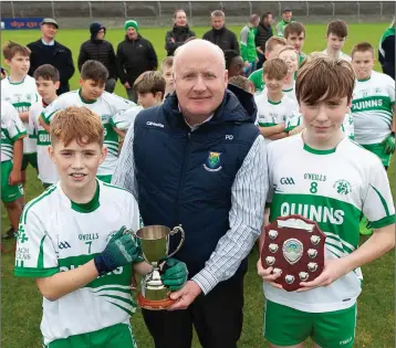  ??  ?? Baltinglas­s captains Jack Kenny and Calum Brophy are presented with the league and championsh­ip cups by the Coiste na nÓg chairman Pat Dunne.