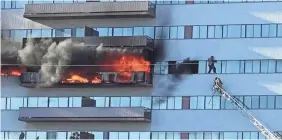  ?? FABIAN VIA AP ?? A Los Angeles firefighte­r on a ladder rescues a man who had climbed out on the side of a 25-story high-rise apartment to escape flames from a burning apartment balcony in West Los Angeles on WednesdayJ­ENNA