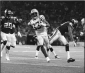  ?? Associated Press ?? SCORE! Packers running back Aaron Jones (33) scores on a 12-yard touchdown run during the second half against the Minnesota Vikings on Monday.