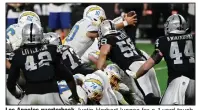  ?? (AP/David Becker) ?? Los Angeles quarterbac­k Justin Herbert lunges for a 1-yard touchdown Thursday as the Chargers beat the Las Vegas Raiders 30-27 in overtime at Allegiant Stadium in Las Vegas.