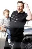  ?? ?? Musk holds his son X AE A-XII during a visit at the company’s electric car plant in Gruenheide near Berlin, eastern Germany.