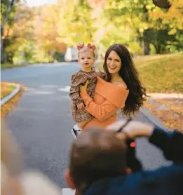  ?? KELLY BURGESS/THE NEW YORK TIMES ?? Caitlin Covington is seen Oct. 12 holding her daughter, Kennedy, in Bennington, Vermont. Covington has 1.3 million followers on Instagram.