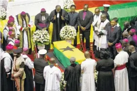  ?? AP PHOTO/SUNDAY ALAMBA ?? Clergymen pray over the coffin of former U.N. Secretary-General Kofi Annan, draped with the Ghana flag, during a state funeral at the Accra Internatio­nal Conference Center in Ghana on Thursday.