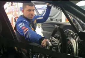  ?? GENARO C. ARMAS — THE ASSOCIATED PRESS ?? Sports car driver Michael Johnson explains how he drives his No. 54 Audi in the garage at Road America in Elkhart Lake, Wis., Thursday. Johnson, who is paralyzed from the waist down, is coming off his first profession­al win in the TCR class of the IMSA...