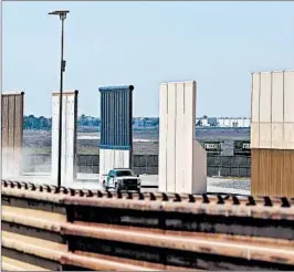  ?? GUILLERMO ARIAS/GETTY-AFP ?? A U.S. Border Patrol truck drives by prototypes for a proposed wall where the U.S. meets Mexico. The administra­tion said that Guard troops would be deployed immediatel­y.