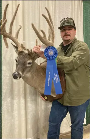  ?? (Arkansas Democrat-Gazette/Bryan Hendricks) ?? Clay Tanner of Corning killed the only non-typical buck to make the top 10 at the Arkansas Big Buck Classic. It placed ninth but set the world record for its class with Bolt and Quarrel, which recognizes game animals taken with crossbows.