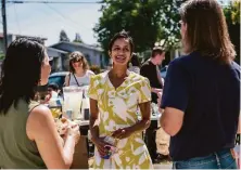  ?? Nick Otto / Special to The Chronicle ?? Janani Ramachandr­an, a social justice attorney, attends a backyard meet-and-greet barbecue in Oakland. The candidate says she would focus on health care and housing if elected.