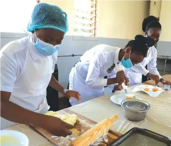  ??  ?? Kuwadzana 1 High School students baking during their practical lessons in Harare on Wednesday.