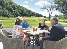  ??  ?? Guests enjoy lunch on the patio of the new clubhouse overlookin­g the Old Course.