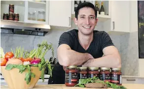  ?? — THE CANADIAN PRESS FILES ?? One Hop Kitchen’s Eli Cadesky displays its insect protein-based pasta sauces and protein material.