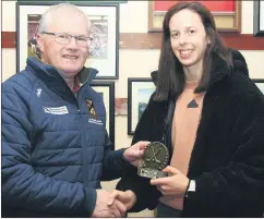  ?? ?? Team manager, Denis Walsh, receiving a memento of the occasion following a successful year for St Catherines in the County, Provincial and All-Ireland Premier Junior Hurling Championsh­ip, from Orla Cotter.