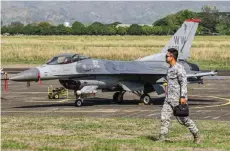  ?? — AFP file photo ?? A Philippine Air Force personnel walks past a US Air Force F-16 fighter jet during the US-Philippine­s joint air force military exercise dubbed ‘Cope Thunder’ at Basa Air Base in Pampanga.