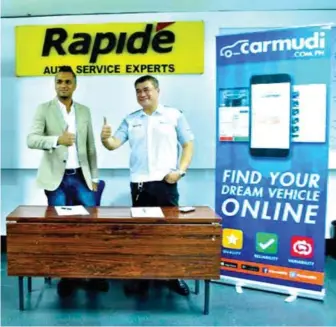  ??  ?? Carmudi Philippine­s Managing Director Abhishek Mohan signs a partnershi­p agreement with Byron Lat, General Manager of Rapide Auto Service Experts.