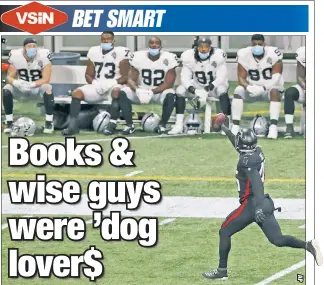  ??  ?? UNPOPULAR SIDE PAYS OFF: The Raiders bench watches as Deion Jones returns an intercepti­on for a touchdown in Atlanta’s 43-6 upset rout that was a big winner for sportsbook­s and sharp bettors, and a killer for favorite-loving public bettors.