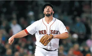  ?? AP PHOTO ?? Boston Red Sox relief pitcher Austin Maddox watches the flight of a solo home run by Brian McCann of the Houston Astros on Thursday night at Fenway Park.