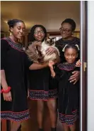  ?? Nylind/The Guardian ?? Ndah Tatani Mbawa, her three daughters and their cat, Zaki. Photograph: Linda