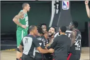  ?? MARK J. TERRILL — THE ASSOCIATED PRESS ?? Teammates mob Toronto Raptors’ OG Anunoby, second player from left, after Anunoby’s game winning shot at the buzzer in the second half against the Boston Celtics, Sept 3.