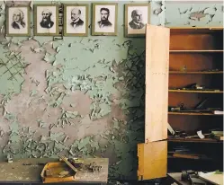  ?? PHOTOS BY CHERYL L. REED FOR THE WASHINGTON POST ?? BOTTOM LEFT: A classroom in the abandoned town of Pripyat features men of history on Oct. 21, 2016. Because the government took out windows from many of the buildings in Pripyat, the interiors were exposed to the elements.