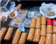  ??  ?? The gold was wrapped in plastic bags covered with yellow adhesive tape and hidden in secret compartmen­ts in the suspect’s bag.