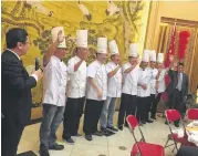  ?? Alison Cook / Houston Chronicle ?? Shandong chefs take a bow during a private dinner at the consul general’s residence in Houston.