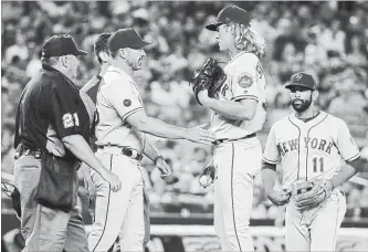  ?? ASSOCIATED PRESS FILE PHOTO ?? New York Mets manager Mickey Callaway, second from left, talks to starting pitcher Noah Syndergaar­d during the sixth inning of the team's interleagu­e baseball game against the Yankees last Friday in New York.