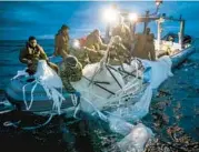  ?? U.S. NAVY ?? Sailors assigned to Explosive Ordnance Disposal Group 2 recover balloon debris Sunday off Myrtle Beach, S.C.