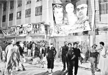  ??  ?? Pakistani security officials gather at the site of a suicide bombing at an election rally in Peshawar. — AFP photo