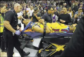  ?? Rich Pedroncell­i The Associated Press ?? Warriors guard Patrick McCaw is taken off the court on a stretcher after falling hard to the floor late in the third quarter Saturday in Sacramento, Calif.