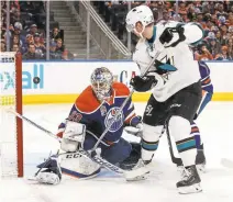  ?? JASON FRANSON/THE CANADIAN PRESS VIAAP ?? The Sharks’ Jannik Hansen scores against Edmonton Oilers goalie Cam Talbot in the first period. The Oilers held on for a 3-2 win.