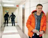  ??  ?? Ffile photo: Russian Ooppositio­n Leader Alexei Navalny stands near law enforcemen­t agents in a hallway of a business centre, which houses the office of his Anti-corruption Foundation (FBK), in Moscow.