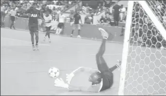  ??  ?? Akel Clarke of Bent Street completing a pivotal save to deny Rio All-Stars in the opening minutes of the Magnum Mash Cup Futsal Championsh­ip at the National Gymnasium, Mandela Avenue.