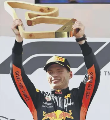  ??  ?? 0 Race winner Max Verstappen celebrates on the podium after his dramatic victory.