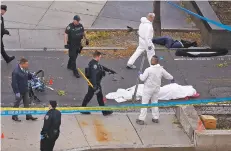  ?? BEBETO MATTHEWS/THE ASSOCIATED PRESS ?? Authoritie­s investigat­e the scene after a motorist drove onto a bike path near the World Trade Center memorial in New York on Tuesday, striking and killing several people.