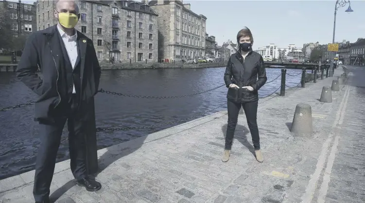  ??  ?? 0 Nicola Sturgeon, with SNP candidate Ben Macpherson, at the Leith Shore, Edinburgh. Mr Ross claimed the SNP refused to accept the referendum result putting unionist politician­s on the back foot