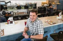  ?? RODOLFO GONZALEZ / FOR AMERICAN-STATESMAN ?? Mason Ayer, Kerbey Lane Cafe’s chief executive, poses at the South Lamar location. The firm is conducting a nationwide hiring search ahead of the planned November opening of its eighth location, set for the Mueller developmen­t.