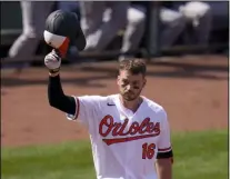  ?? JULIO CORTEZ - THE ASSOCIATED PRESS ?? Baltimore Orioles’ Trey Mancini tips his helmet as fans give him a standing ovation prior to batting against the Boston Red Sox during the first inning of a baseball game, Thursday, April 8, 2021, on Opening Day in Baltimore.