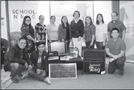  ??  ?? Smart meets three of its latest School-in-a-Bag recipients. In photo are Smart employees led by chief people and culture officer Liza Sichon (center) and People Group AVP Cheryll Agsaoay (standing fourth from left), and representa­tives of Trangka...