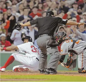  ?? STAFF PHOTO BY JOHN WILCOX ?? SAFE! Chris Young slides home with a run in the seventh inning of the Sox' 8-1 win last night at Fenway.