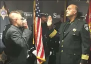  ??  ?? Above and below, Rensselaer County Sheriff Pat Russo administer­s the oath to new correction­s officers at the Rensselaer County Correction­al Facility.